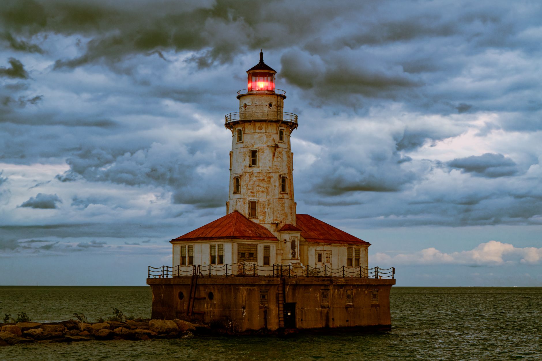 spooky lighthouse under a cloudy sky at the end of the chicago harbor breakwater